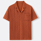 Textured jacquard knit polo in burnt orange