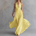Plunging halter open back pleated maxi dress in yellow