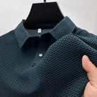 Featherlight waffle knit polo shirt in petrol blue